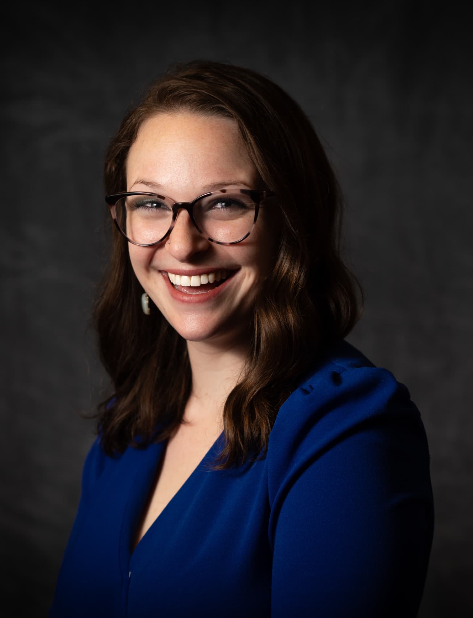 Brynn Jacobs smiling, wearing glasses